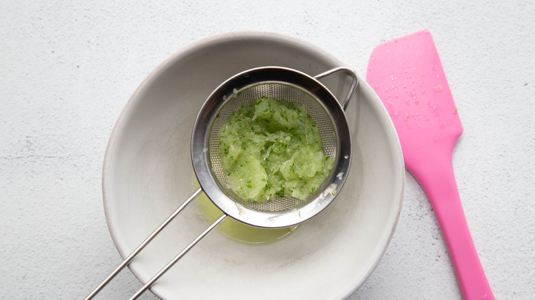 grated cucumber in a colander