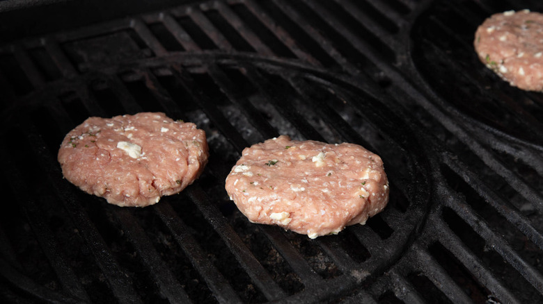 raw turkey patties on a grill