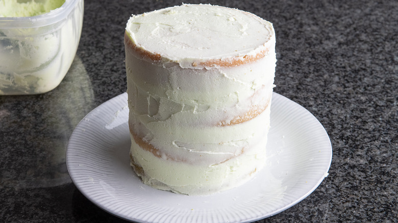 tiered frosted cake on plate 