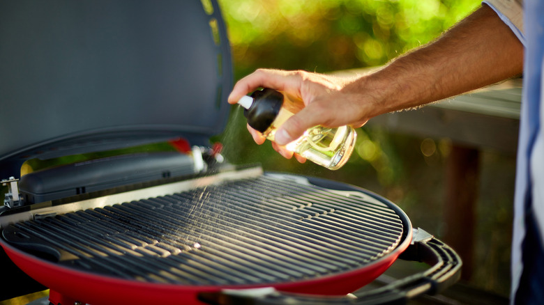 spraying oil on grill