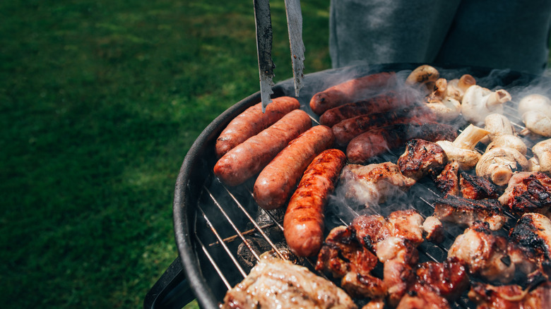 sausage and meats cooking on grill