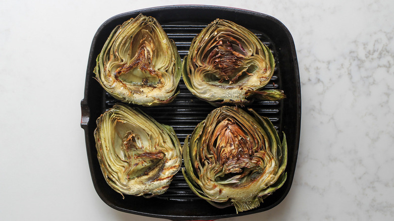 halved artichokes on grill