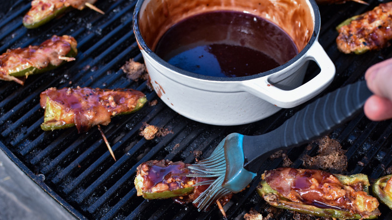 brushing jalapeño poppers with glaze