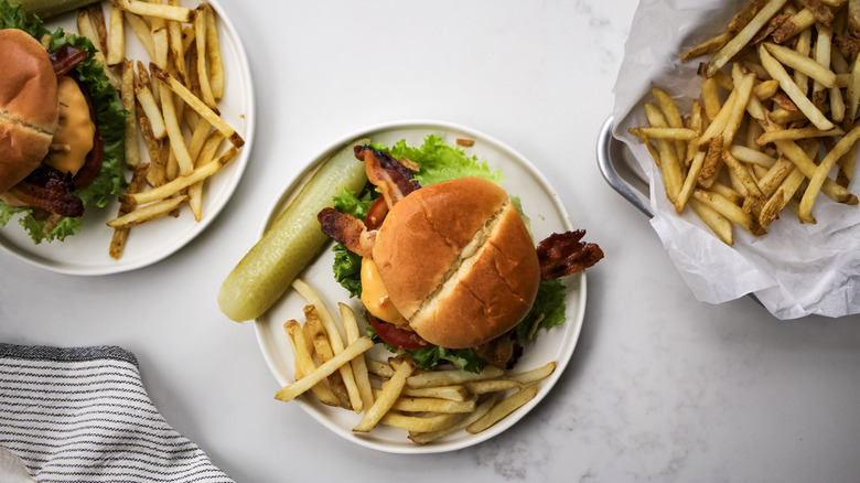 burgers and fries on plates