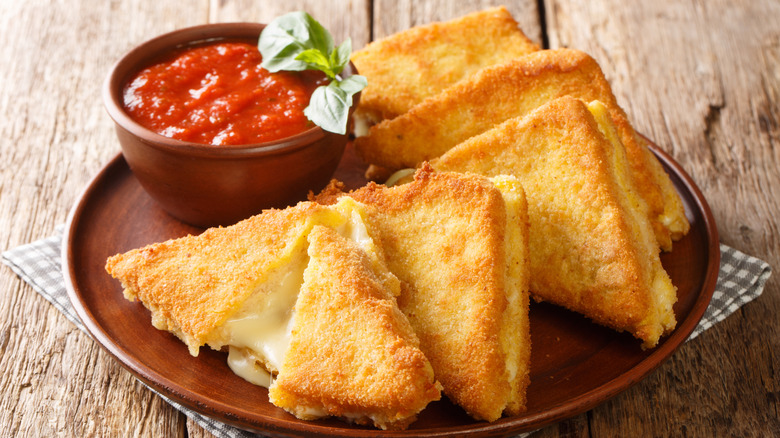 Italian mozzarella in carrozza served on a plate with a side of marinara