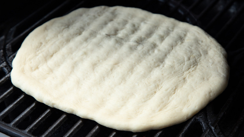 pizza dough on grill