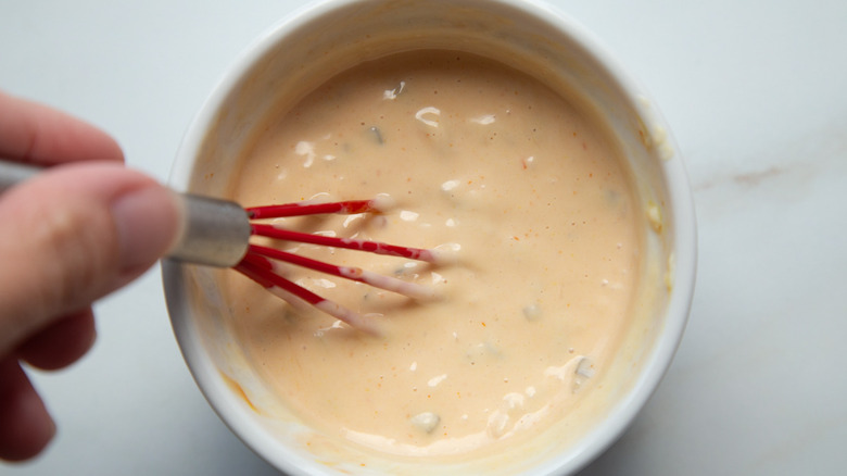 whisking burger sauce