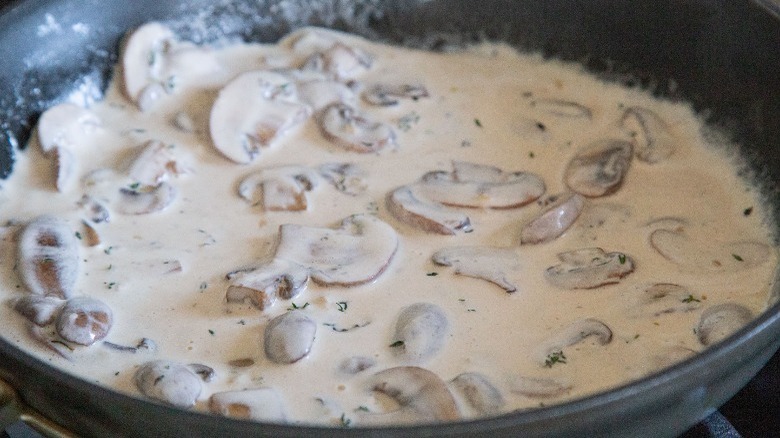 mushrooms cooking in cream sauce