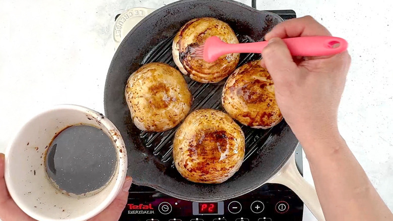 brushing marinade over mushrooms