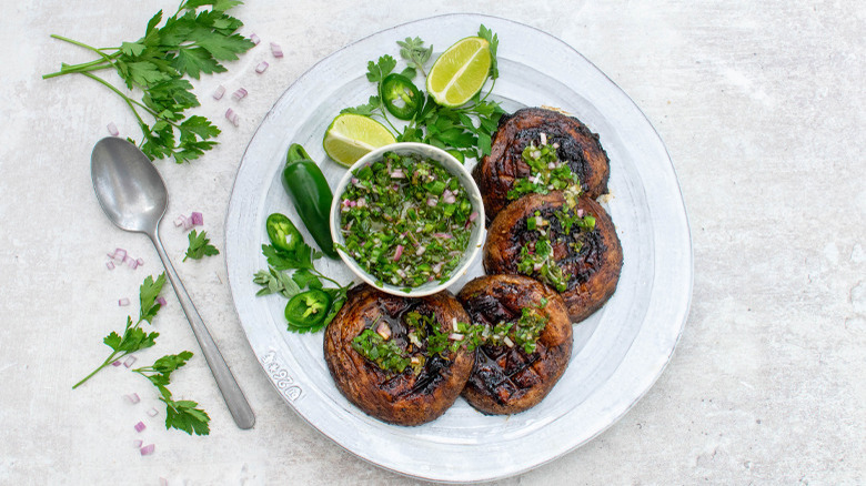 serving plate with grilled portobello mushrooms with jalapeño chimichurri