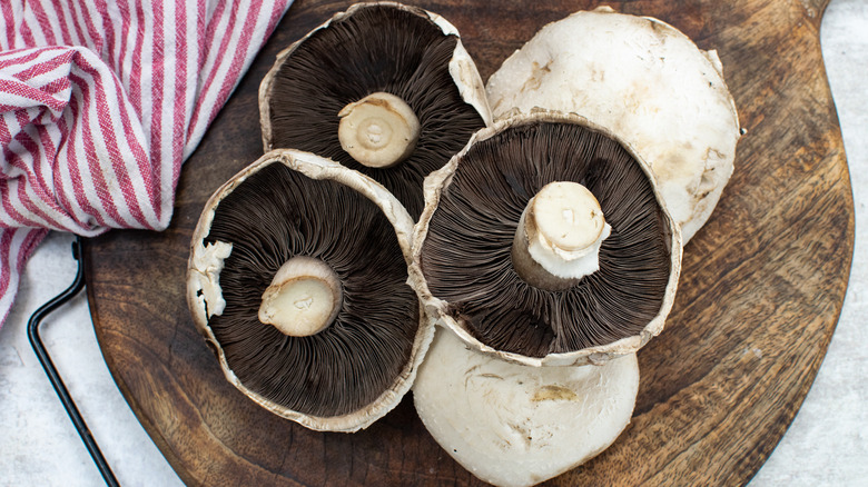 portobello mushrooms on chopping board