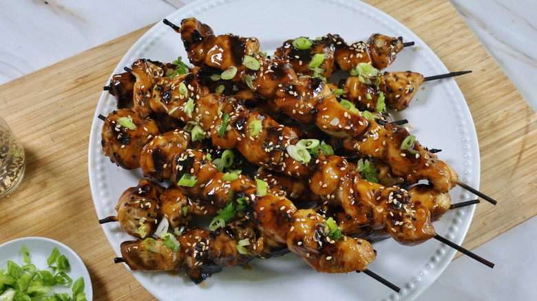 plate of grilled sesame chicken skewers