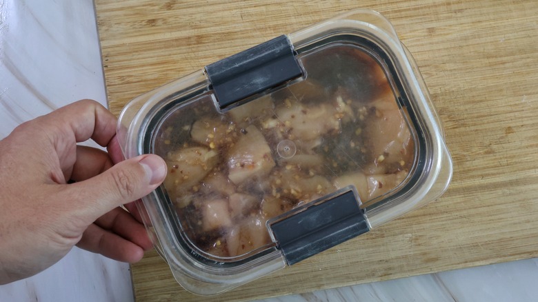 container of marinating chicken