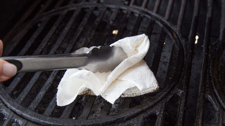 fingers holding tongs and towel