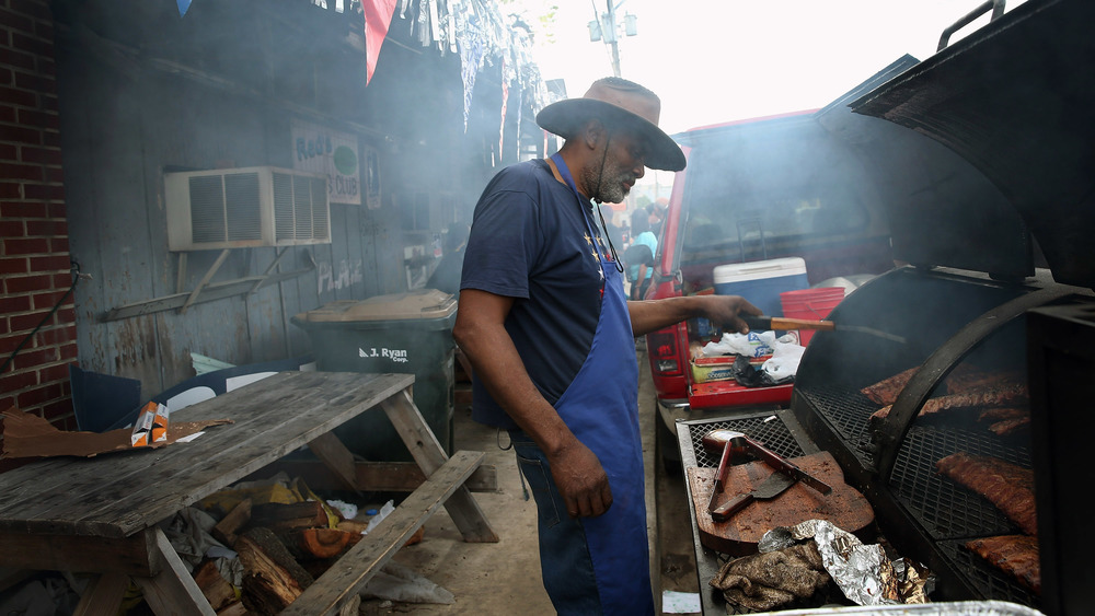 Pitmaster smoking ribs outside