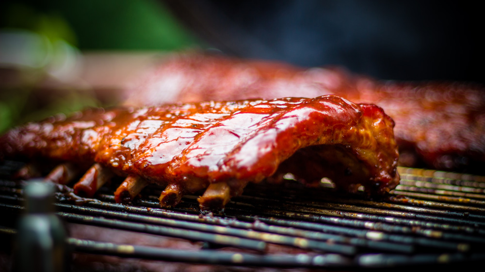 Ribs on a grill with barbecue sauce