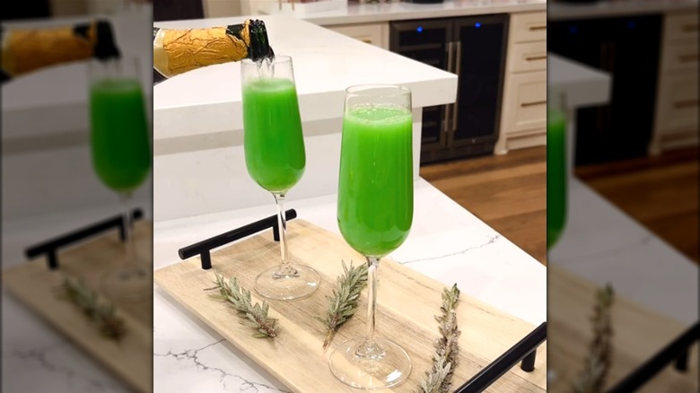 pouring champagne into green mimosa