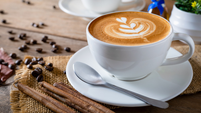 A cappuccino with coffee beans