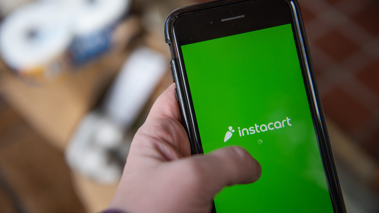 Person opening the Instacart app on a mobile phone