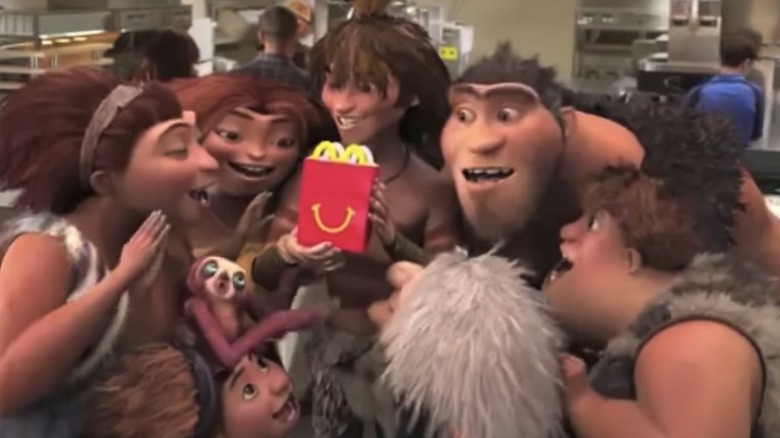 The Croods crowd around a happy meal