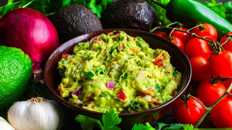 Guacamole surrounded by ingredients