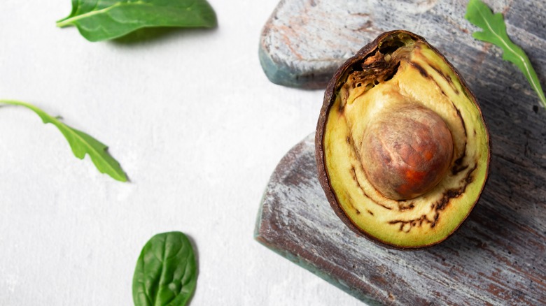 Overripe avocado on a cutting board