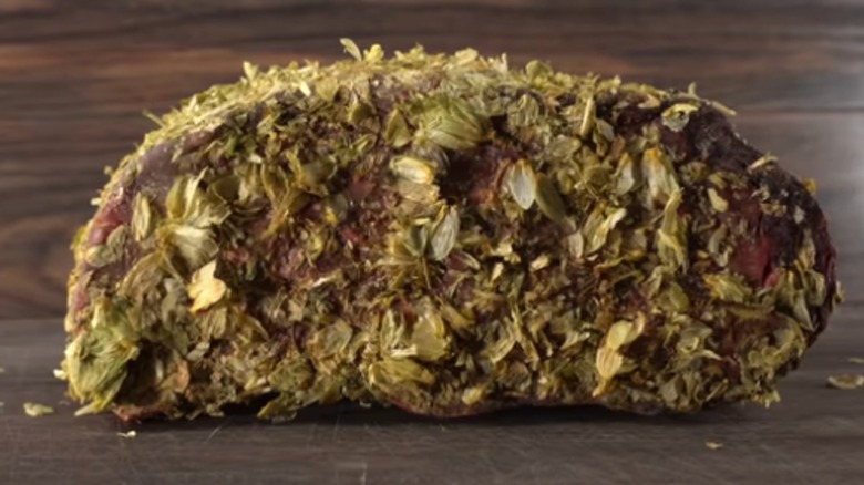 dry-aged steak covered in hops leaves and beer