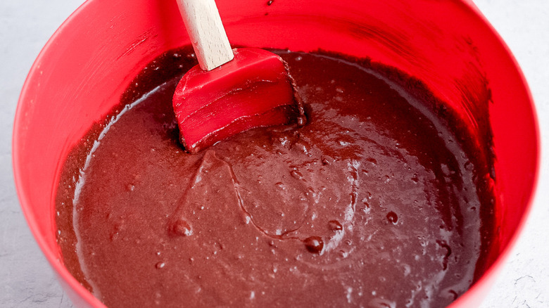 brownie batter in red bowl