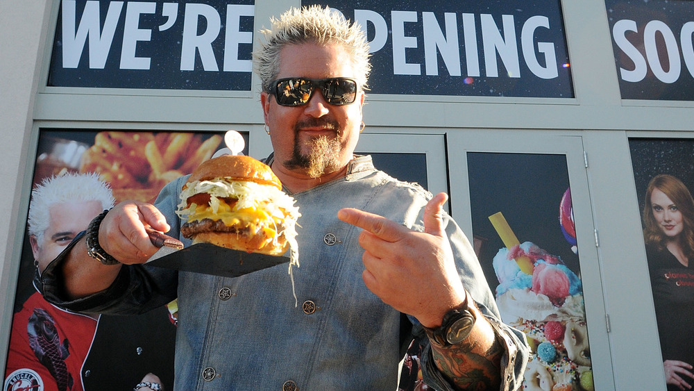 Guy Fieri holding a burger