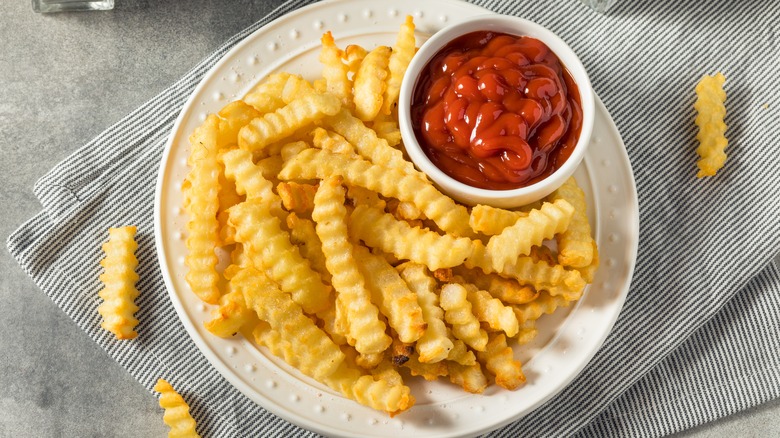 crinkle cut french fries with ketchup