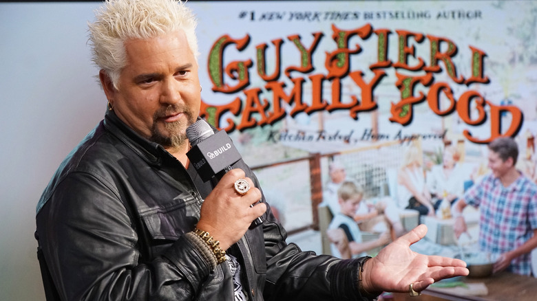 Guy Fieri speaking into a mic