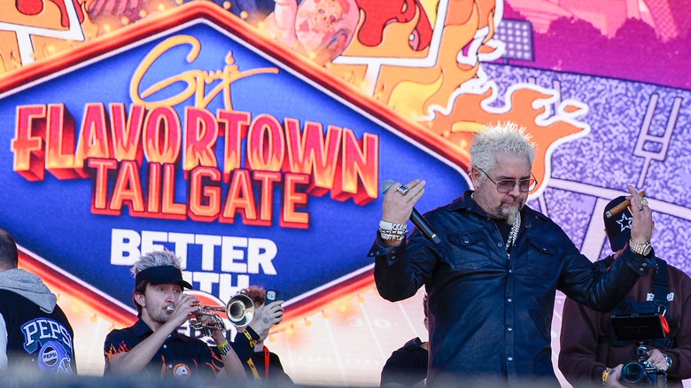 Guy fieri with Guy's Tailgate sign