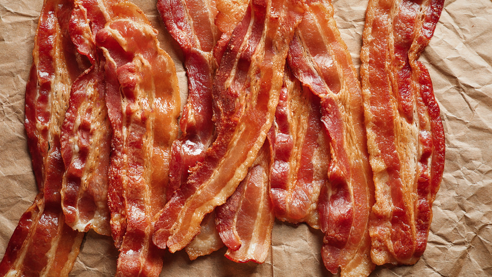 Strips of bacon on parchment paper