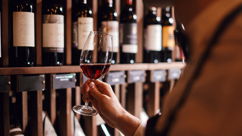 Glass of wine with bottles in background