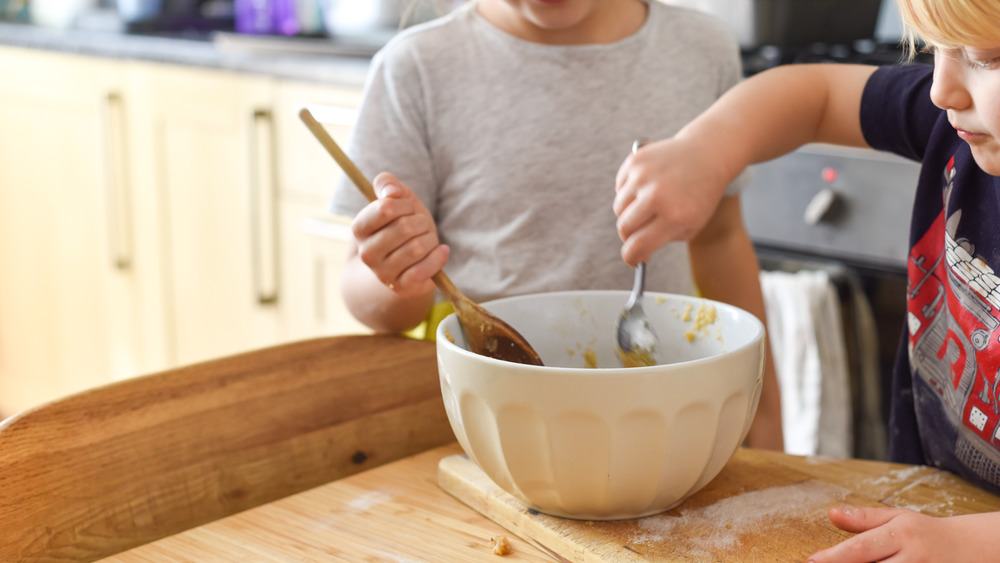 two kids mixing cookie dough