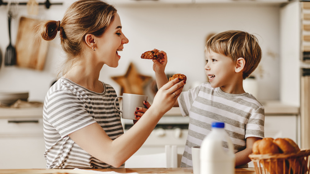 mom and son sharing cookies and milk