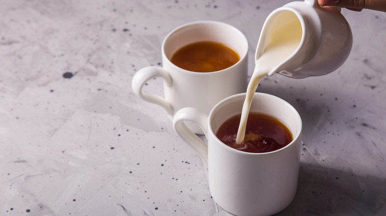 pouring cream in coffee