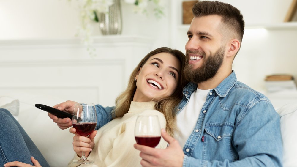 couple drinking wine watching tv