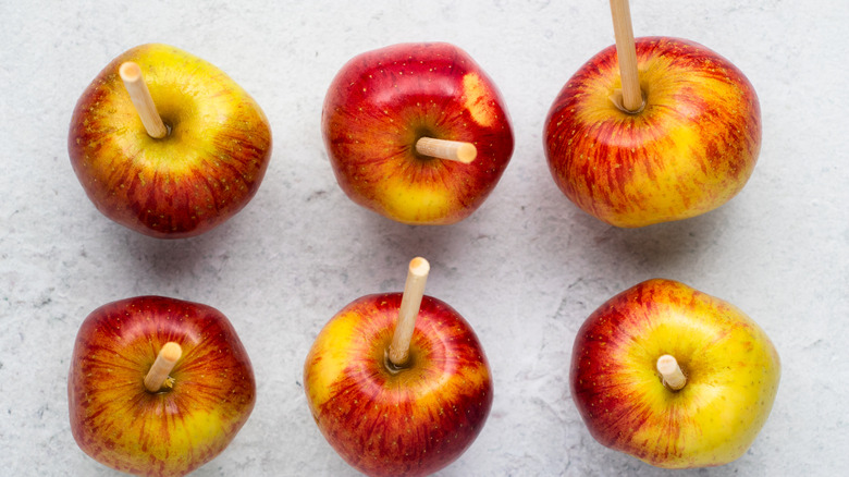 apples with sticks inserted