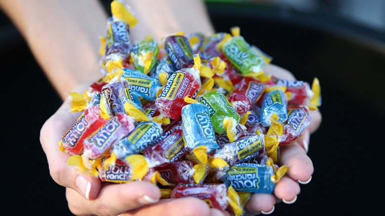 Jolly Ranchers candy in hands