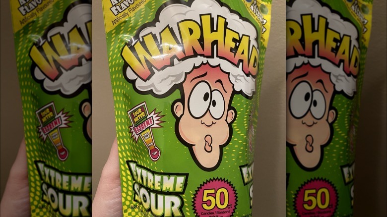 Hand holding bag of Warheads