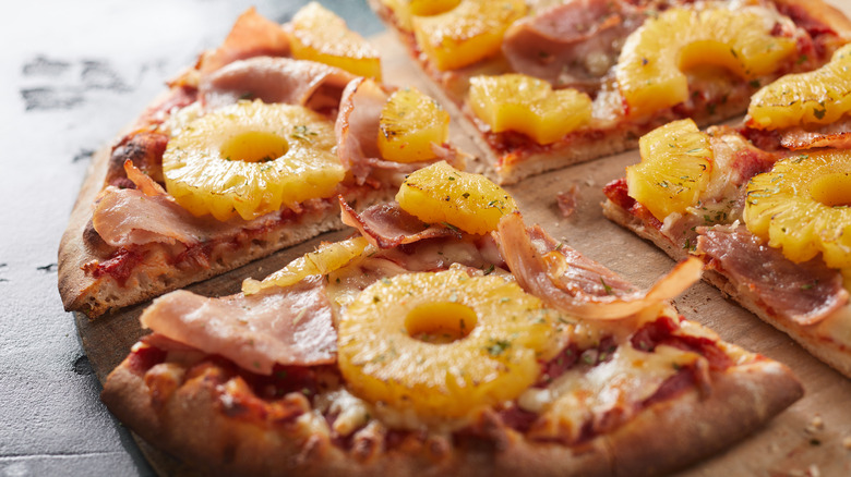 Four slices of Hawaiian Pizza