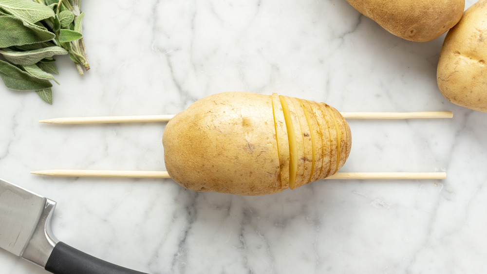 slicing hasselback potatoes