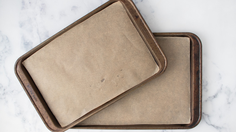 Two baking sheets lined with parchment paper