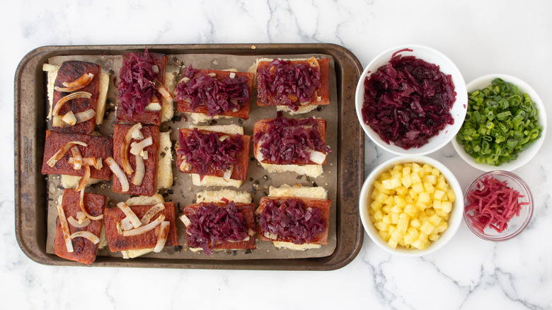 Spam sliders next to bowls of toppings