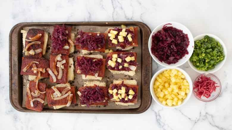 Spam sliders next to bowls of toppings