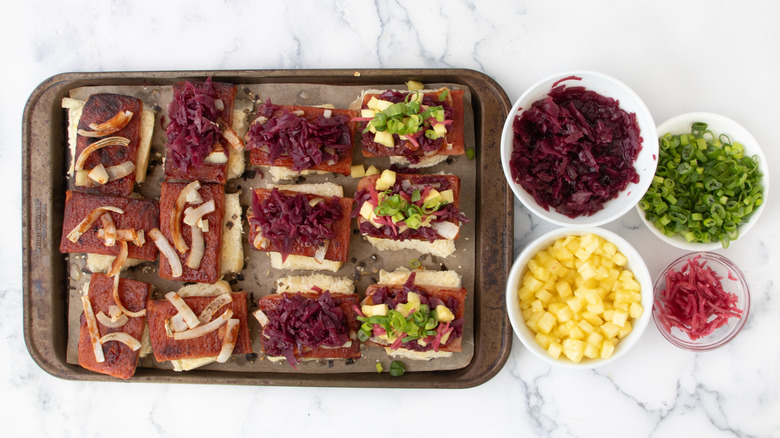 Spam sliders next to bowls of toppings