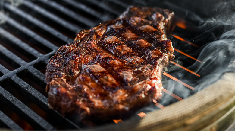 Steak cooking on a grill