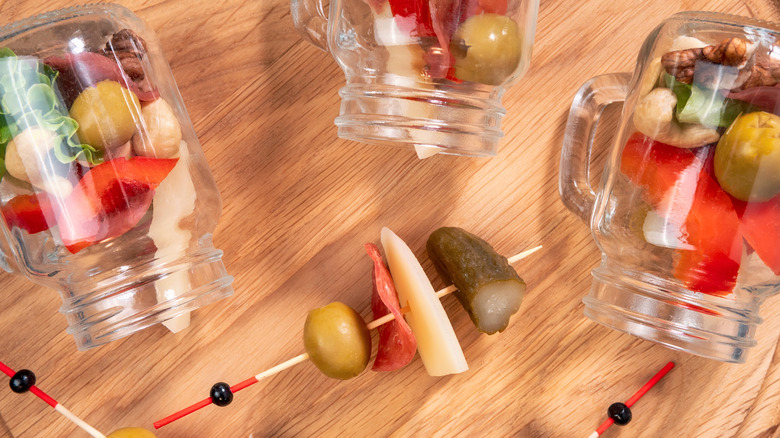 Jarcuterie ingredients on wood background