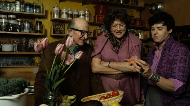 Julia Child in a kitchen with Paul Child and a guest